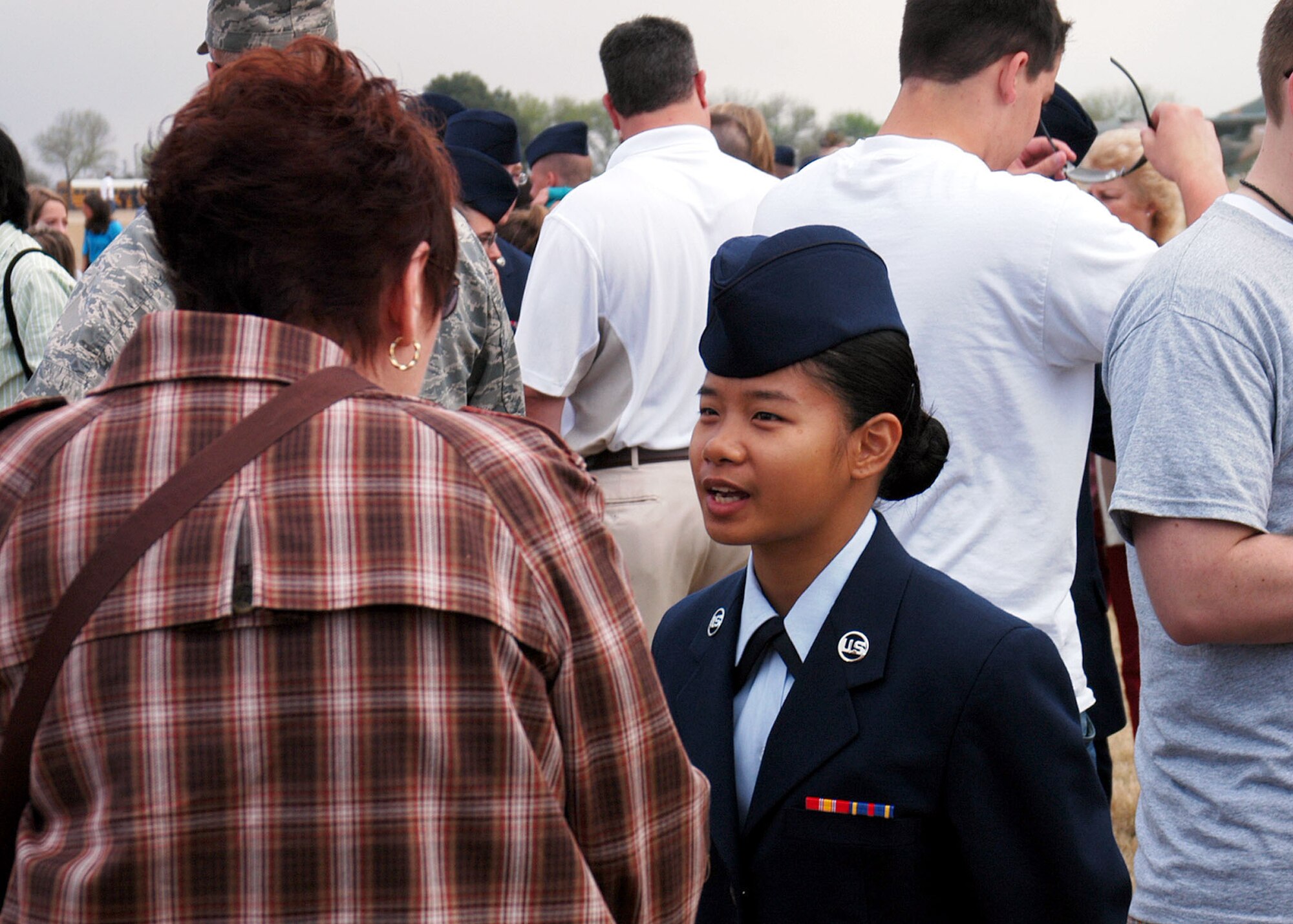 An Air Force Recruiting Service Distinguished Educator Tour guest speaks with an Air Force Basic Military Training graduate at Lackland Air Force Base, Texas, following the graduation ceremony March 14. Air Force Recruiting Service conducts two tours annually that provide high school and community college counselors, teachers and principals the opportunity to learn about Air Force opportunities for their brightest students by way of attending briefings, viewing training, and speaking with trainees and experienced Airmen. (U.S. Air Force photo/Staff Sgt. Jennifer Lindsey)