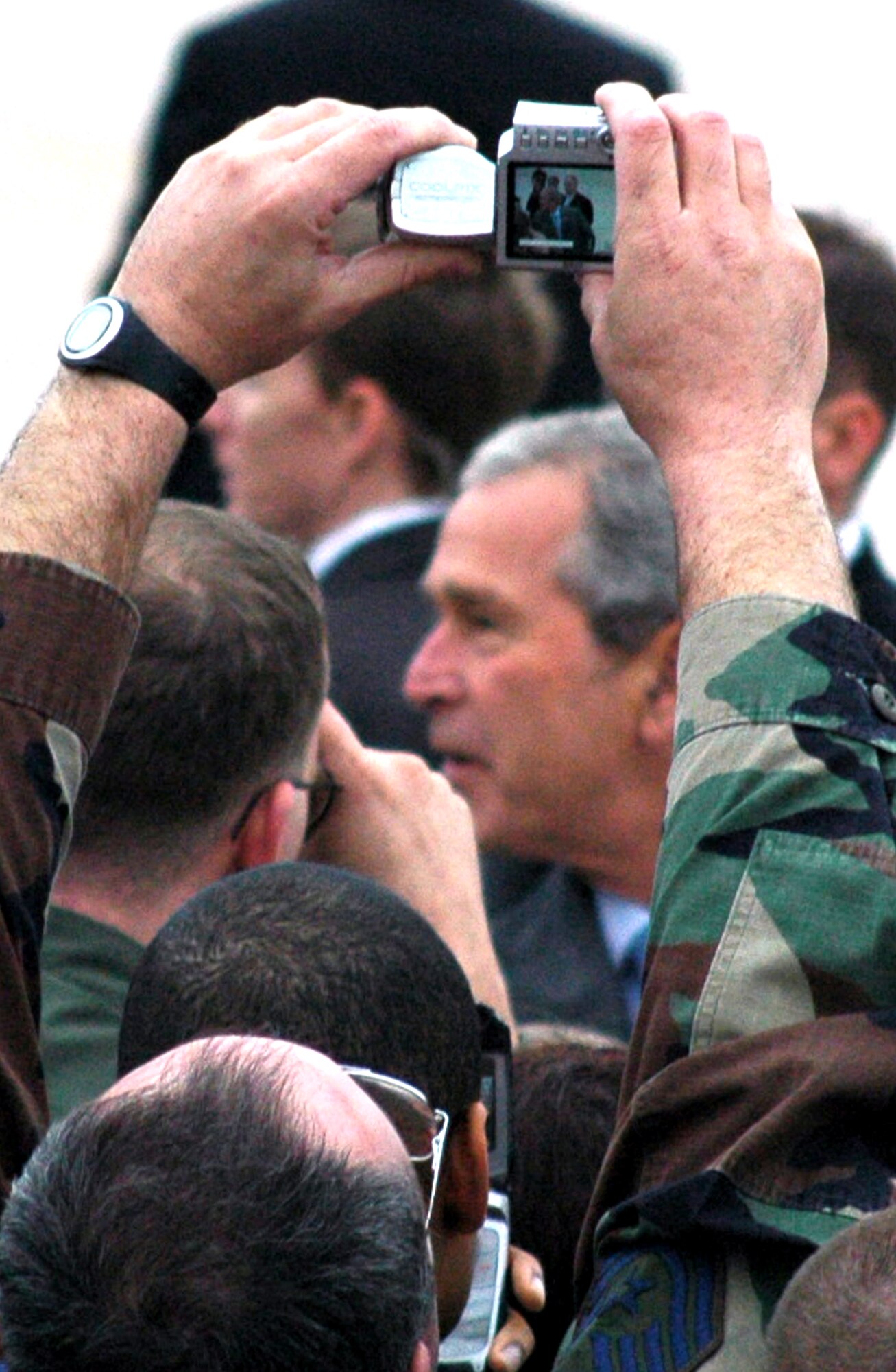 An Airman snaps a photo while the President of the United States George Bush shakes hands and greets Airmen at McGuire Air Force Base, N.J., March 28, 2008.  The President came through McGuire en route to a pre-scheduled visit to Freehold, N.J.  (U.S. Air Force Photo/Tech. Sgt. Scott T. Sturkol)