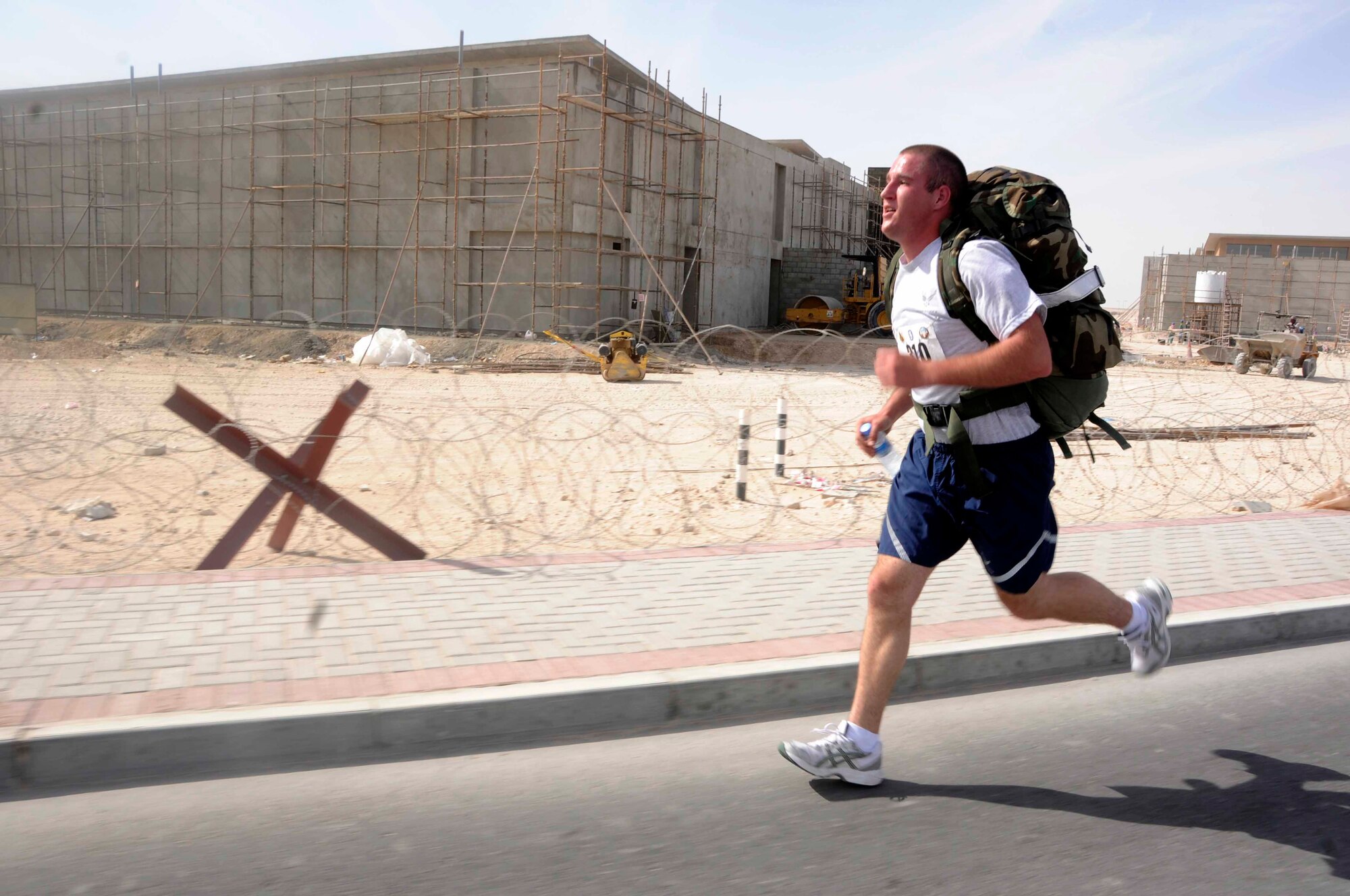 Airman 1st Class Trent Sturguess, 379th Expeditionary Security Forces Squadron, runs the fourth leg of the Bataan Death March Memorial Marathon with a 35-lb rucksack March 29. Airman Sturguess and three other teammates relayed the length of the entire march. (U.S. Air Force photo/ Senior Airman Domonique Simmons)