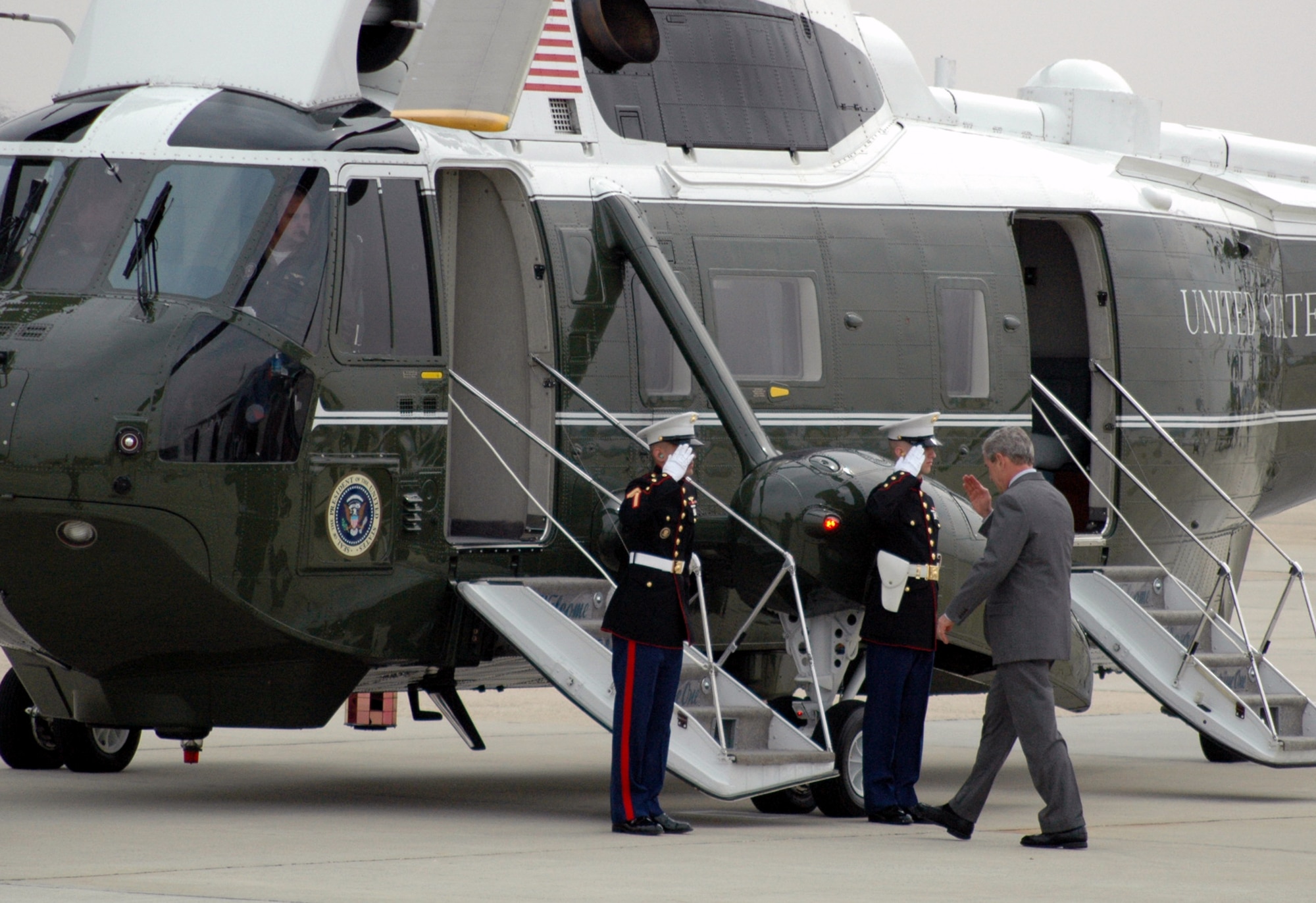 Two U.S. Marines assigned to "Marine One" salute President of the United States George W. Bush as he prepares to board the presidential helictopter at McGuire Air Force Base, N.J., March 28, 2008.  The President stopped at McGuire en route to Freehold, N.J.  (U.S. Air Force Photo/Tech. Sgt. Scott T. Sturkol)