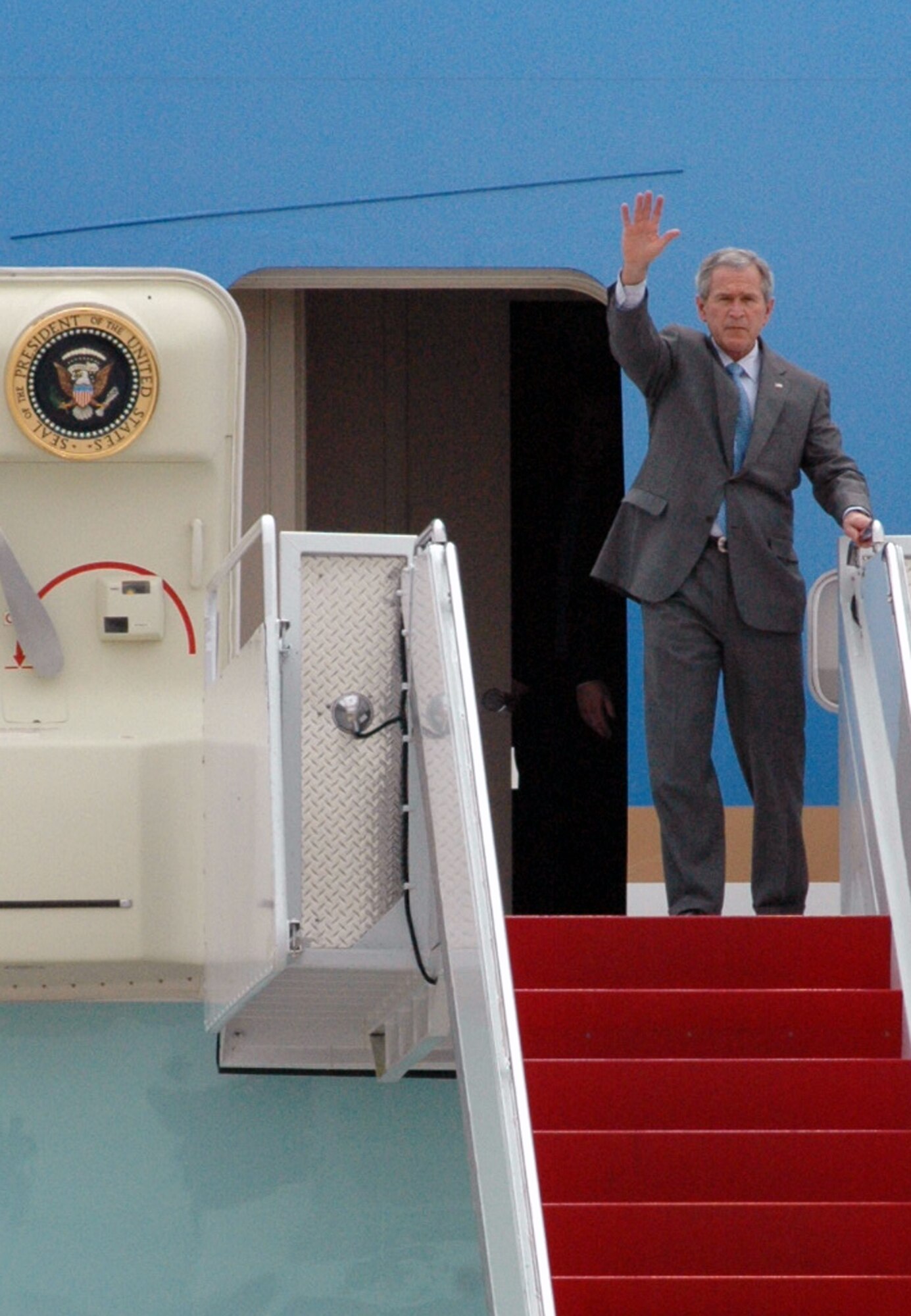 President of the United States George W. Bush waves to a crowd of waiting Airmen and others after arriving at McGuire Air Force Base, N.J., March 28, 2008.  The President's plane, Air Force One, stopped at the base en route to a visit in Freehold, N.J.  (U.S. Air Force Photo/Tech. Sgt. Scott T. Sturkol)