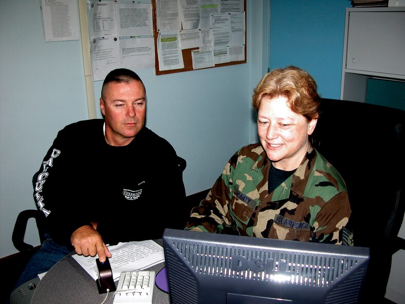 Tech. Sgt. Diana McCarty, 919th Mission Support Flight customer service chief, scans Michael Howard's fingerprint as a form of identification for a new ID card. Servicemembers requesting new ID cards are now required to present two forms of ID before being issued a new card. Acceptable forms of ID include an expired military ID card, driver's license, social security card, passport, birth certificate, or permament resident card. 