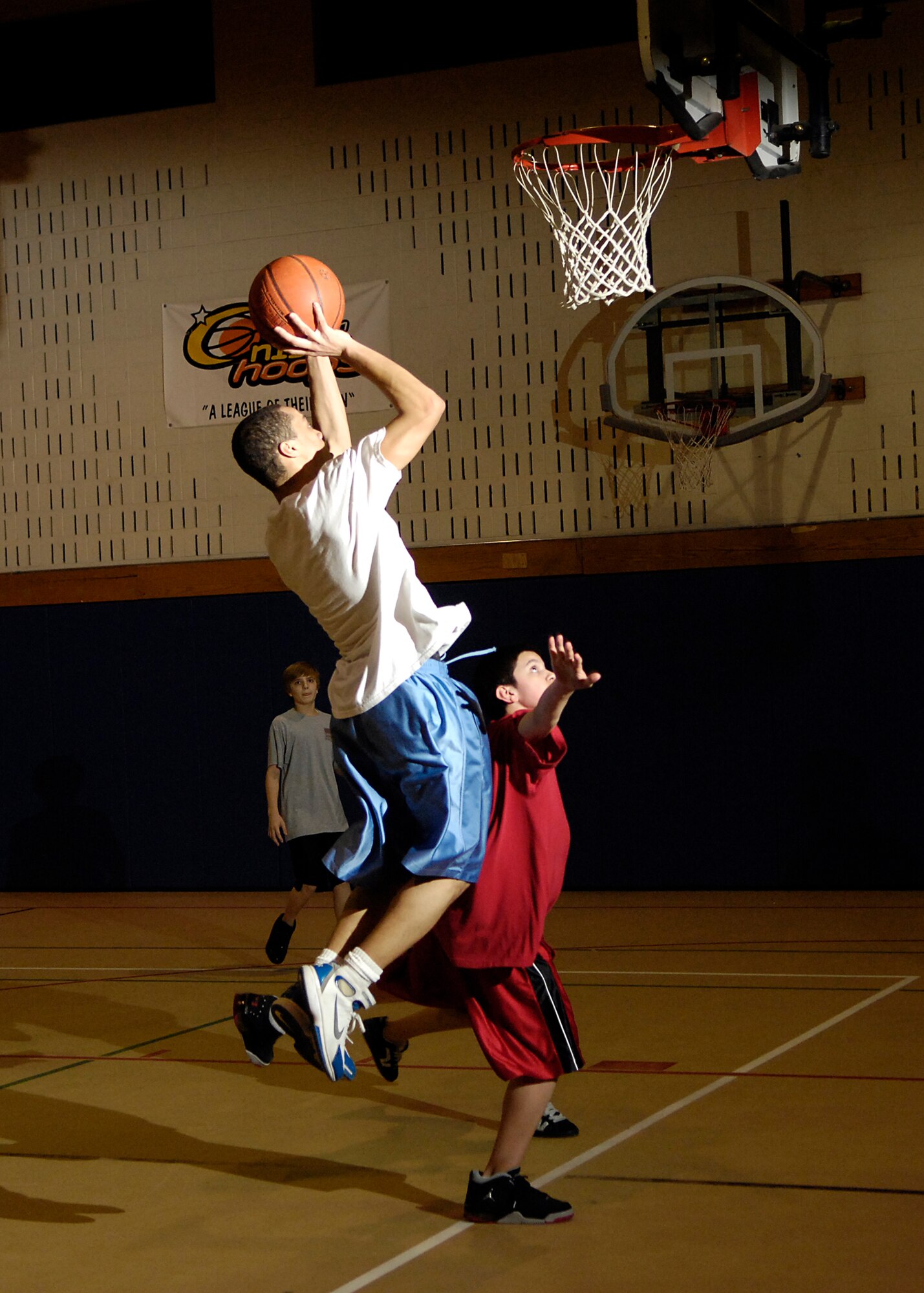 HANSCOM AFB, Mass. – Participants in the Operation Night Hoops program take the ball to the net on March 28. The program ran throughout the month of March for teens ages 13 to 18. Operation Night Hoops was sponsored by the Youth Center and volunteers from the 66th Security Forces Squadron. (U.S. Air Force photo by Mark Wyatt)