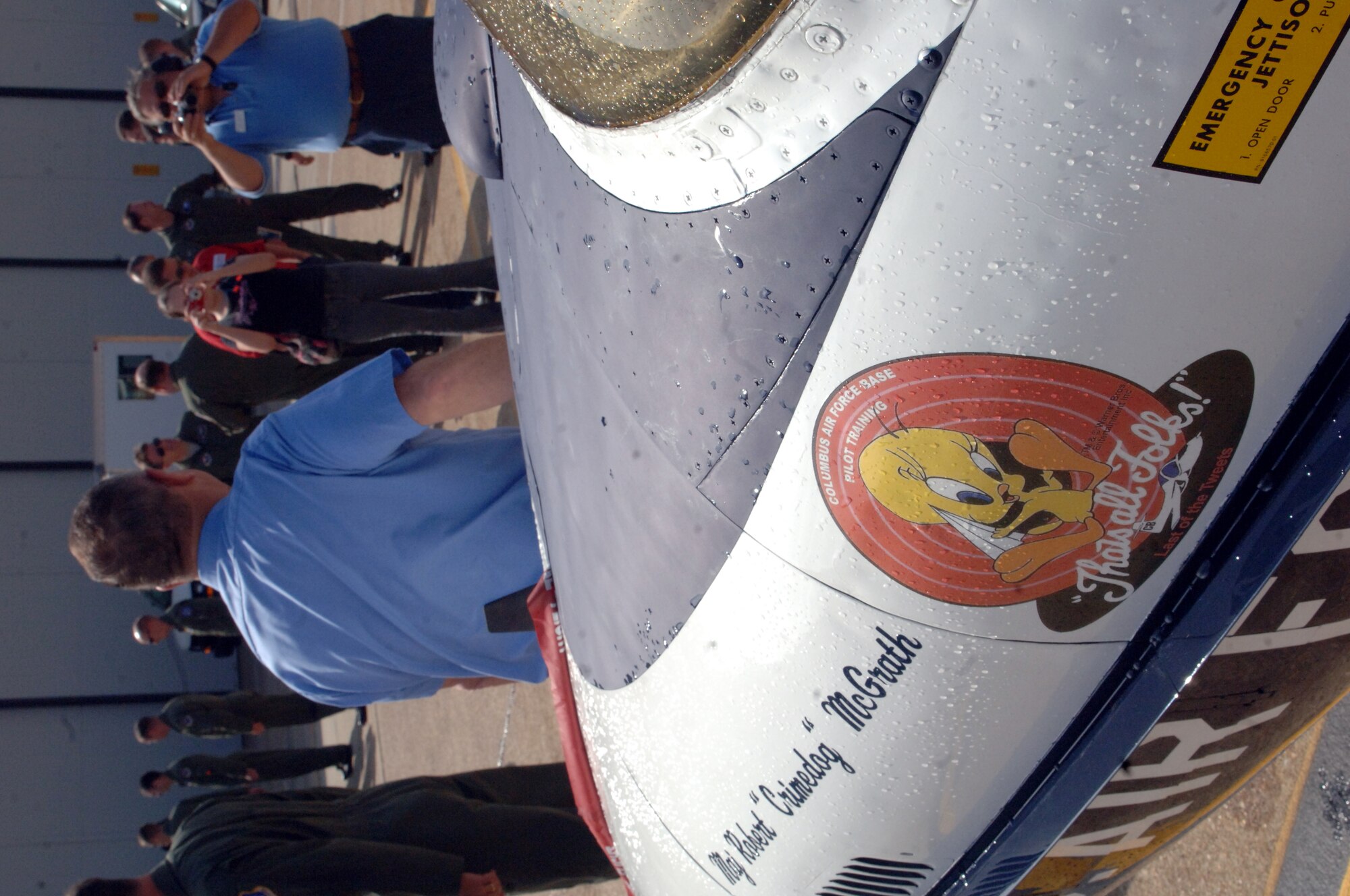 Gordon Gober, T-37 DynCorp crew chief, stands in front of his aircraft for a photo following the successful completion of the final T-37 “Tweet” student training sortie at Columbus Air Force Base March 31. The T-37 is being replaced by the T-6 Texan II. The T-37 will be officially retired from Columbus AFB Specialized Undergraduate Pilot Training during a ceremony April 3. Photo by Senior Airman John Parie