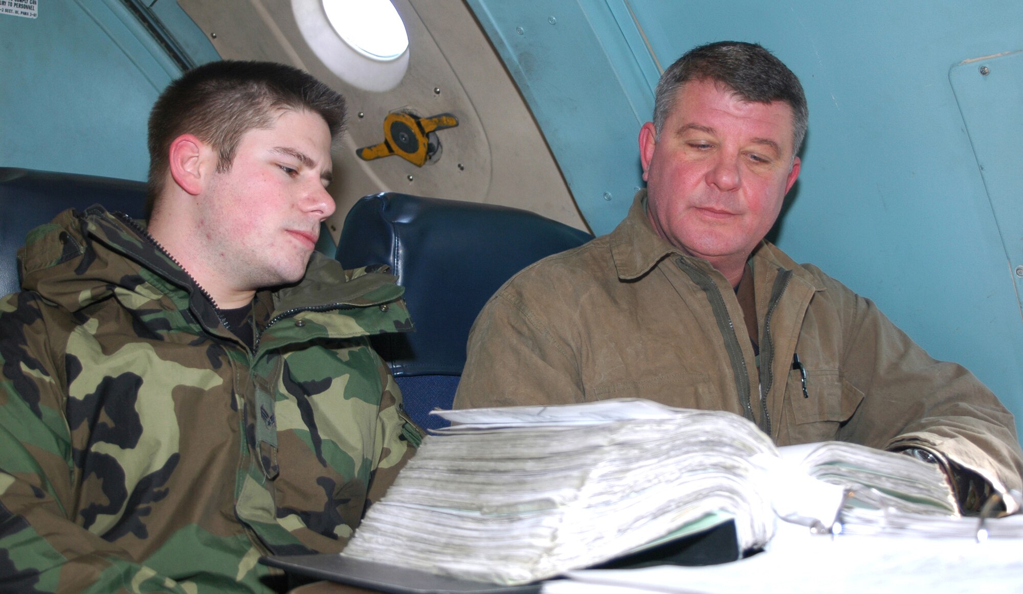 Tech. Sgt. James Blake (right), 512th Aircraft Maintenance Squadron C-5 maintenance crew leader, reviews maintenance information with Senior Airman Blake Bufogle on board a C-5 Galaxy during the March UTA. Sergeant Blake was selected as the Reserve Associate Maintenance Technician of the Year and now competes at the 22nd Air Force level. 
