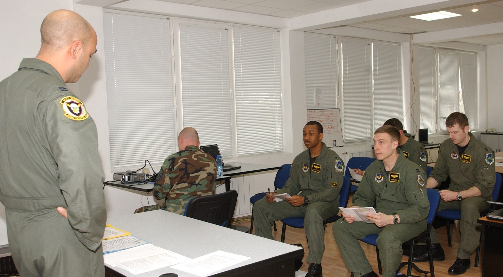 Capt Danny Cannon, 493rd Expeditionary Fighter Squadron chief of scheduling, briefs aircrews prior to a mission supporting the NATO summit in Romania April 1 .  (U.S. Air Force photo by Tech. Sgt. J. LaVoie)