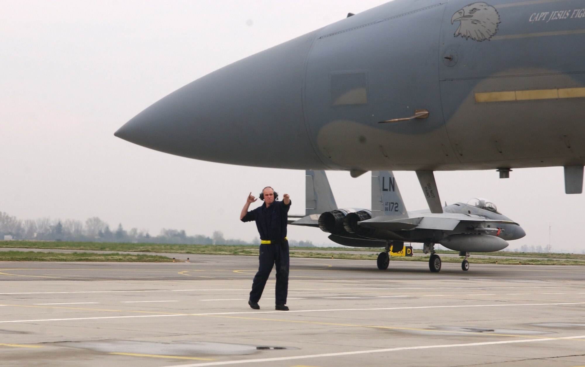 Airman 1st Class Daniel Addabbo, 493rd Expeditionary Fighter Squadron assistant dedicated crew chief, marshals an F-15C Eagle April 1 which will fly a mission in support of Operation Noble Endeavor.  U.S. F-15s, with support from Bulgaria, are augmenting NATO’s air policing mission for the NATO summit. (U.S. Air Force photo by Tech. Sgt. J. LaVoie)