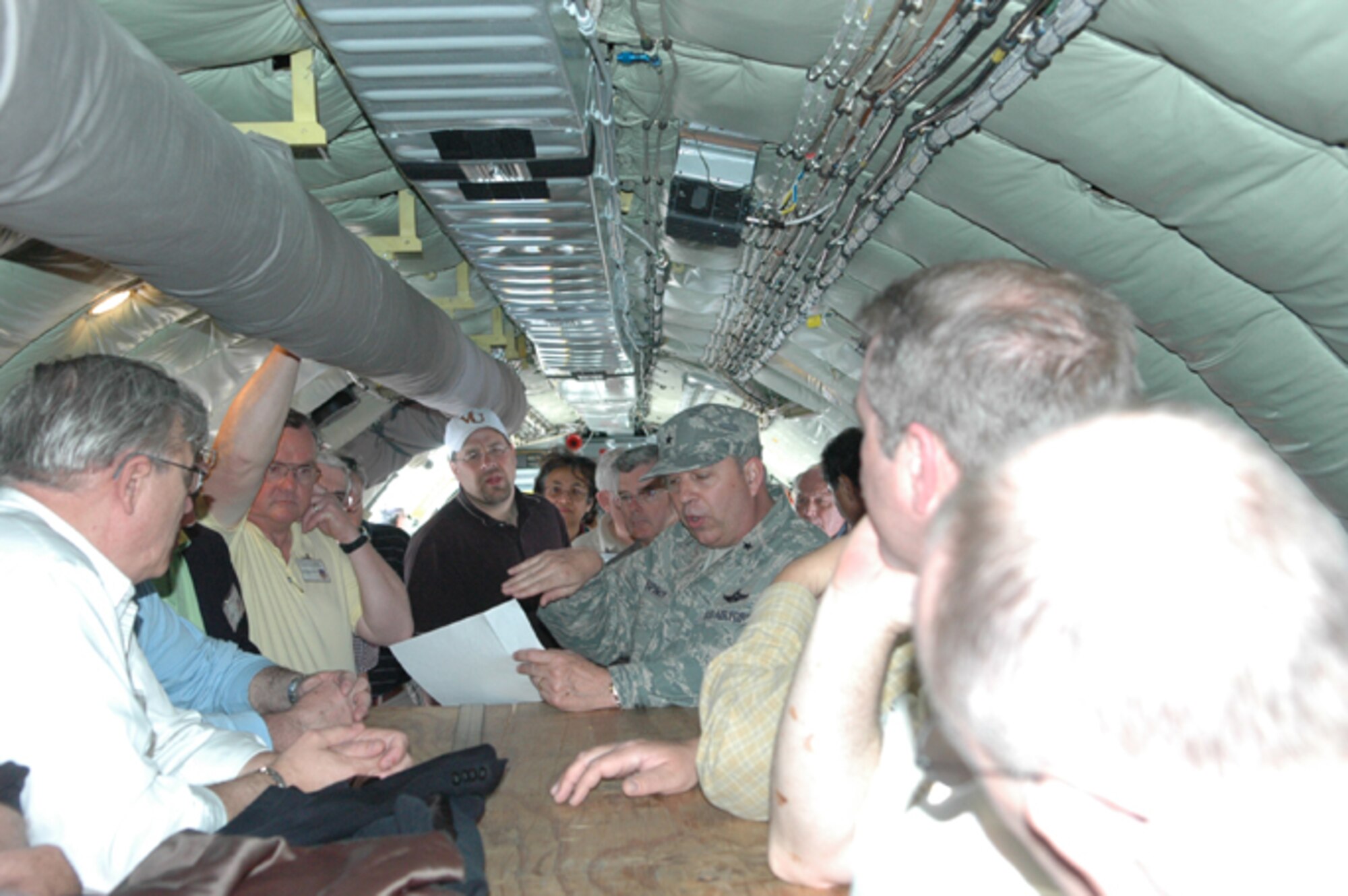 GRISSOM AIR RESERVE BASE, Ind., -- Brig. Gen. Dean Despinoy (center), 434th Air Refueling Wing Commander, briefs civic leaders aboard a KC-135R Stratotanker enroute from Naval Station Mayport, Fla., to Grissom ARB.  The mission included a mid-air refueling with a C-130 gunship and the general outlined the basic procedures to the civic leaders.  (U.S. Air Force photo/Senior Airman Carl Berry)