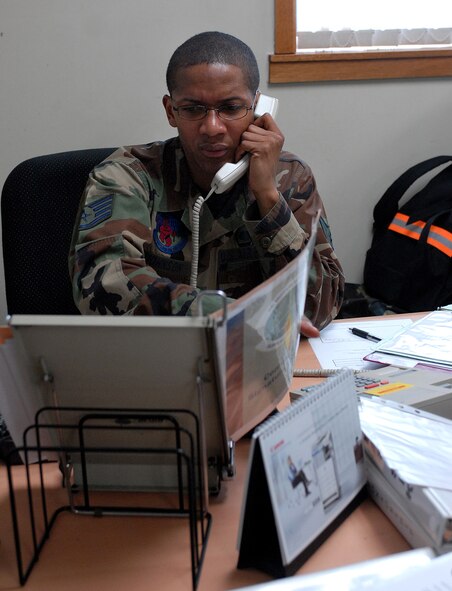 KUNSAN AIR BASE, Republic of Korea -- Staff Sgt. Randy Johnson, 8th Mission Support Group Intro Program Manager, answers calls from 8th MSG Airmen here March 28.  The Mission Support Group support staff streamlines the process to accept follow on forces so that the Wolf Pack can accomplish its three-tier mission. (U.S. Air Force photo/ Senior Airman Giang Nguyen)