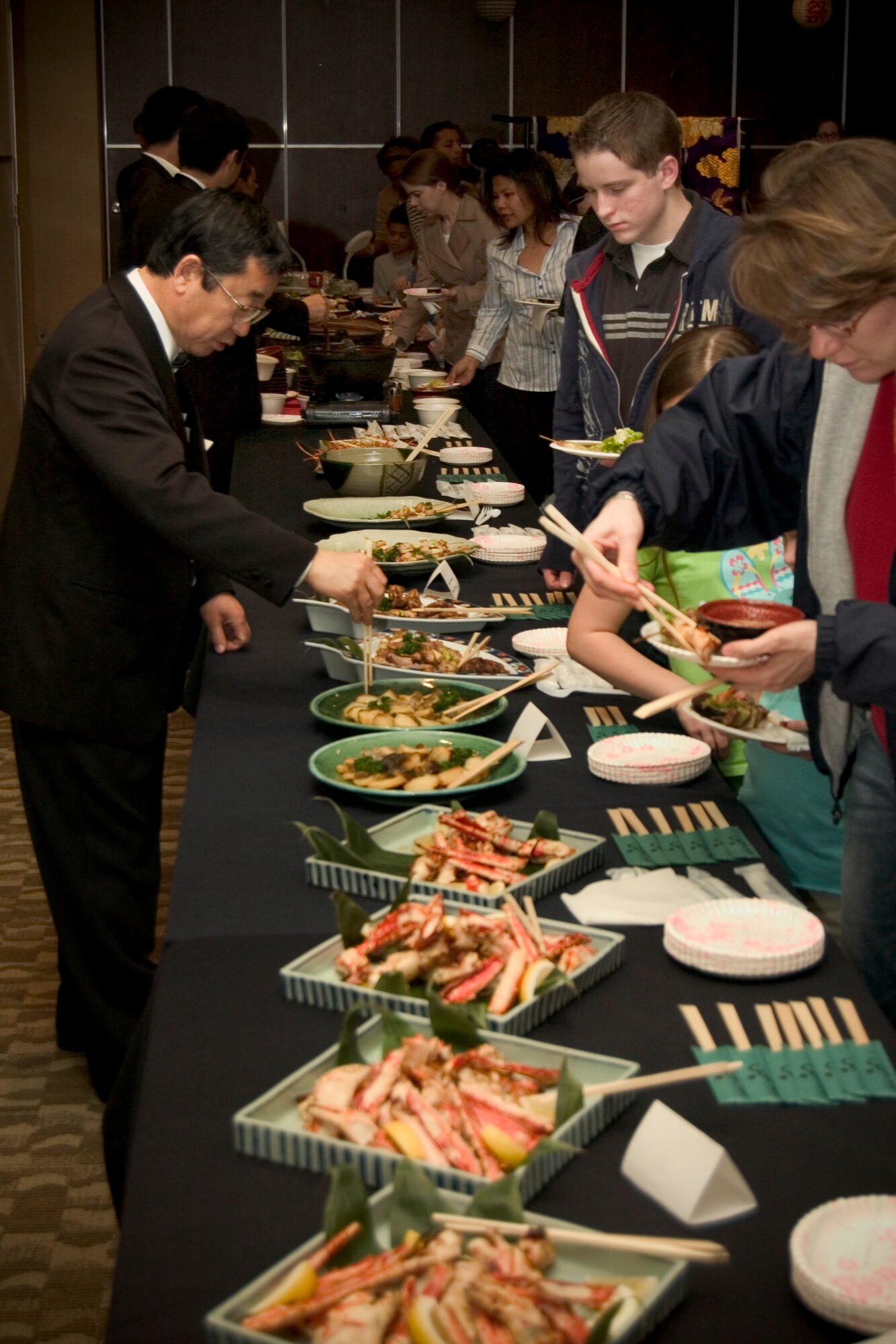 MISAWA AIR BASE, Japan -- Hungry guests line up for the buffet on March 22, 2008 at the Mokuteki Community Center. The buffet, part of the Ocha Kai celebration, introduced Americans on the base to a wide variety of traditional Japanese food. (U.S. Air Force photo by Senior Airman Samuel Morse)