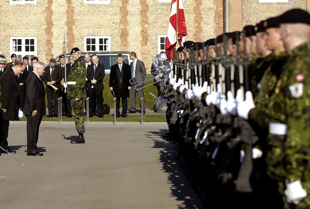 Defense Secretary Robert M. Gates, second from left, receives an honors salute from Royal Danish troops at the Royal Lifeguard Barracks in Copenhagen, Denmark, April 1, 2008.