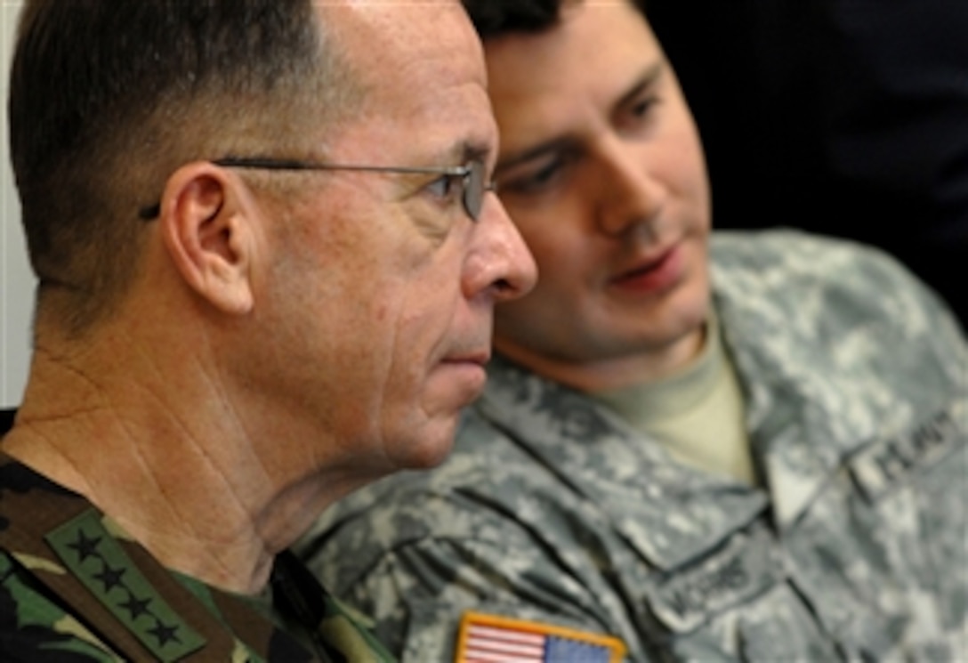 Navy Adm. Mike Mullen, chairman of the Joint Chiefs of Staff, listens to an Arabic translation by Army Sgt. 1st Class Robert Morris at the U.S. Army Special Warfare Center and School on Fort Bragg, N.C., March 31, 2008. Mullen sat in on a class with special forces soldiers who are being trained in Arabic.