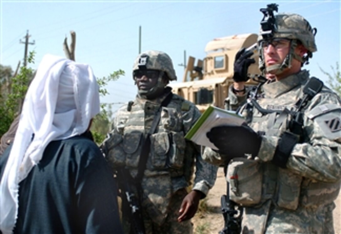U.S. Army 1st Lt. Bryan Diminico, right, takes down information with a translator, Spc. Simon Nbyenye, from an orchard farmer in al Buaytha, March 25, 2008. Diminico is a platoon leader assigned to the 1st Platoon, Company D, 1st Battalion, 30th Infantry Regiment.