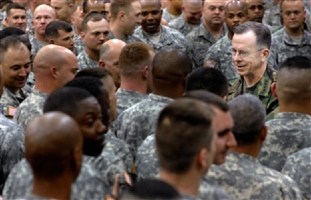 U.S. Navy Adm. Mike Mullen, chairman of the Joint Chiefs of Staff, hands out several hundred of his signature coins to soldiers and airmen following an all-hands call at the Ritz-Epps Physical Fitness Center on Fort Bragg, N.C., March 31, 2008. 
