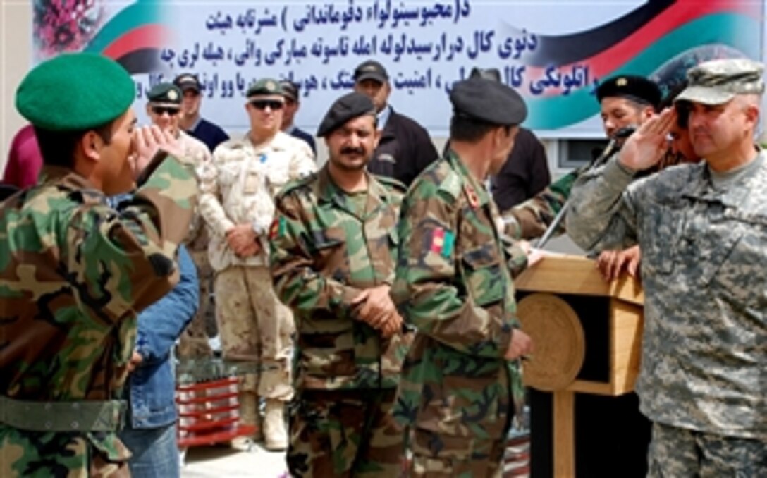 U.S. Army Col. Anthony Zabek salutes an Afghan national army soldier as he graduates, March 30, 2008, at the Afghan National Detainee Facility in Kabul, Afghanistan. More than 40 Afghan soldiers completed a seven-week correction specialist course on riot control, detainee transport, feeding operations, emergency response and security. 