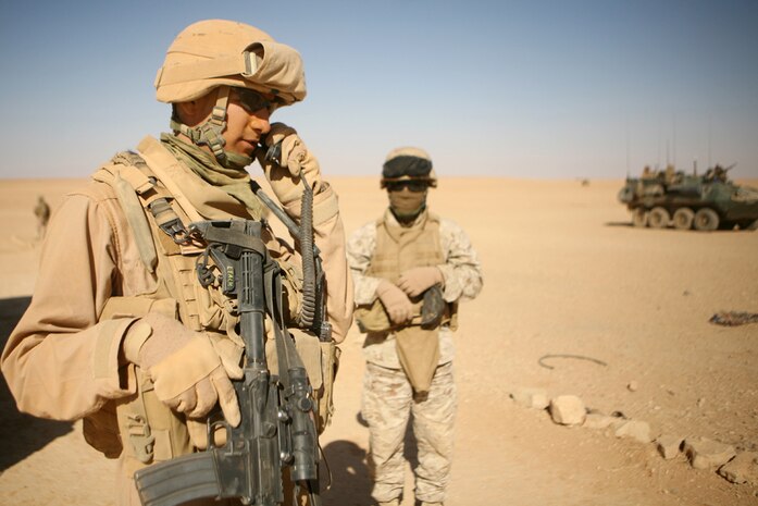Using his communications system to inform others of the situation, Sgt. James D. Leach, a scout squad leader with Delta Company, 2nd Light Armored Reconnaissance Battalion, Regimental Combat Team 5, conducts a house search while patrolling through western Al Anbar province, Iraq, June 1. Delta Co., known as "Outlaw," is now attached to Task Force Mechanized, a unit comprised of Marines from 1st Tank Battalion, Regimental Combat Team 5, and Combat Logistics Battalion 6, 1st Marine Logistics Group (Fwd), in support of the Operation Defeat Al Queda in the North.