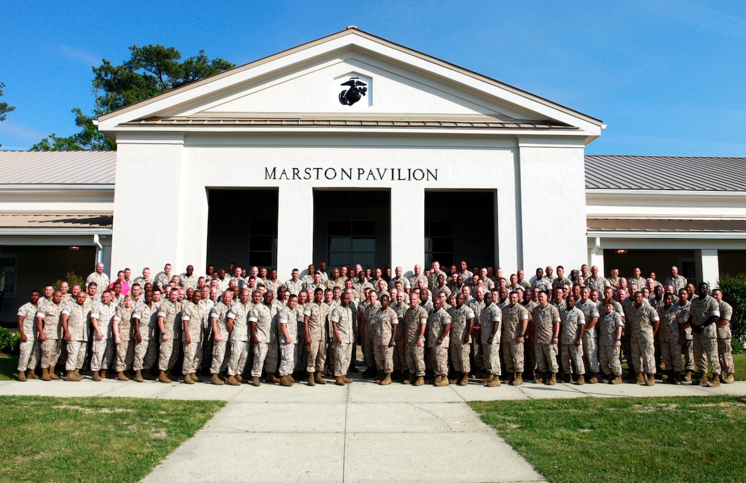 Senior enlisted Marines and sailors throughout Marine Corps Forces Command, pose for a photo during annual Sergeant Major, Master Gunnery Sergeant and Master Chief Symposium at the Marston Pavilion aboard Marine Corps Base Camp Lejeune, N.C., May 3, 2011. The seasoned vets covered a multitude of topics that military personnel and their families deal with on a daily basis. (U.S. Marine Corps photograph by: Cpl. Matthew P. Troyer.)