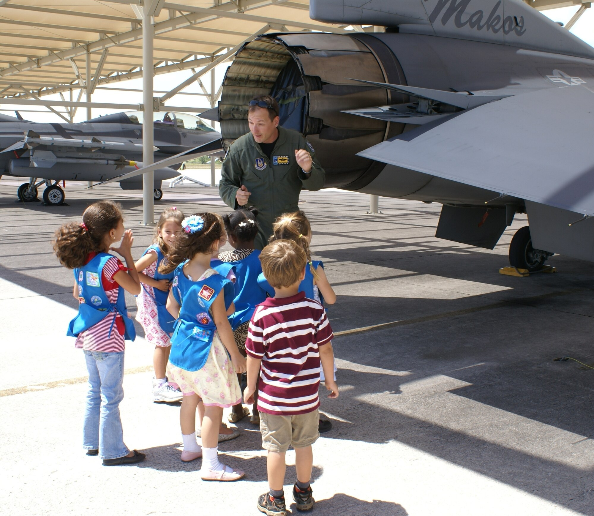 Maj. Sean Gustafson, 93rd Fighter Squadron pilot, talks to a group of Daisy Girl Scouts from Troop 466, Palmetto Bay, Fla., about the capabilities of the F-16, March 28.  The scouts were treated to an afternoon tour of the base that was highlighted by a presentation of special participation badges. Ranging in ages of 5-6 years old, Daisy Scouts are part of the Girl Scouts of the United States of America, that go on trips, learn about nature and science, and explore the arts and their communities. Homestead Air Reserve Base offers two tours each month for students or community organizations. (U.S. Air Force photo/Nelly Veneros) 