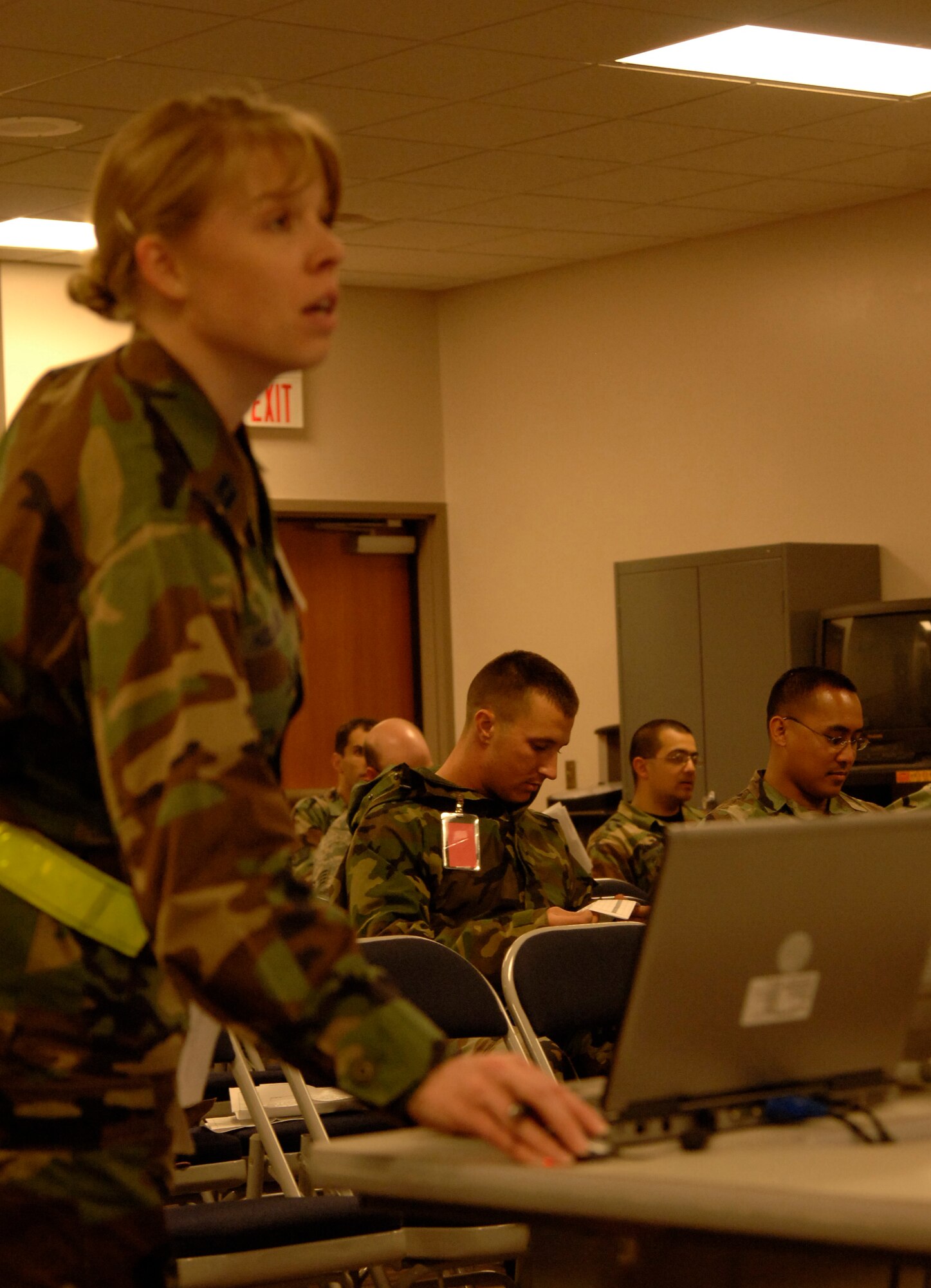 MCCONNELL AIR FORCE BASE, Kan. -- Capt. Tammy Hollister, 22nd Mission Support Squadron, briefs McConnell members who are deploying at Bldg. 1090, March 29. Briefings in a personnel deployment facility line inform deploying military members on legal matters, chaplain services and conditions and information on the deployed location. (Photo by Senior Airman Roy Lynch III)