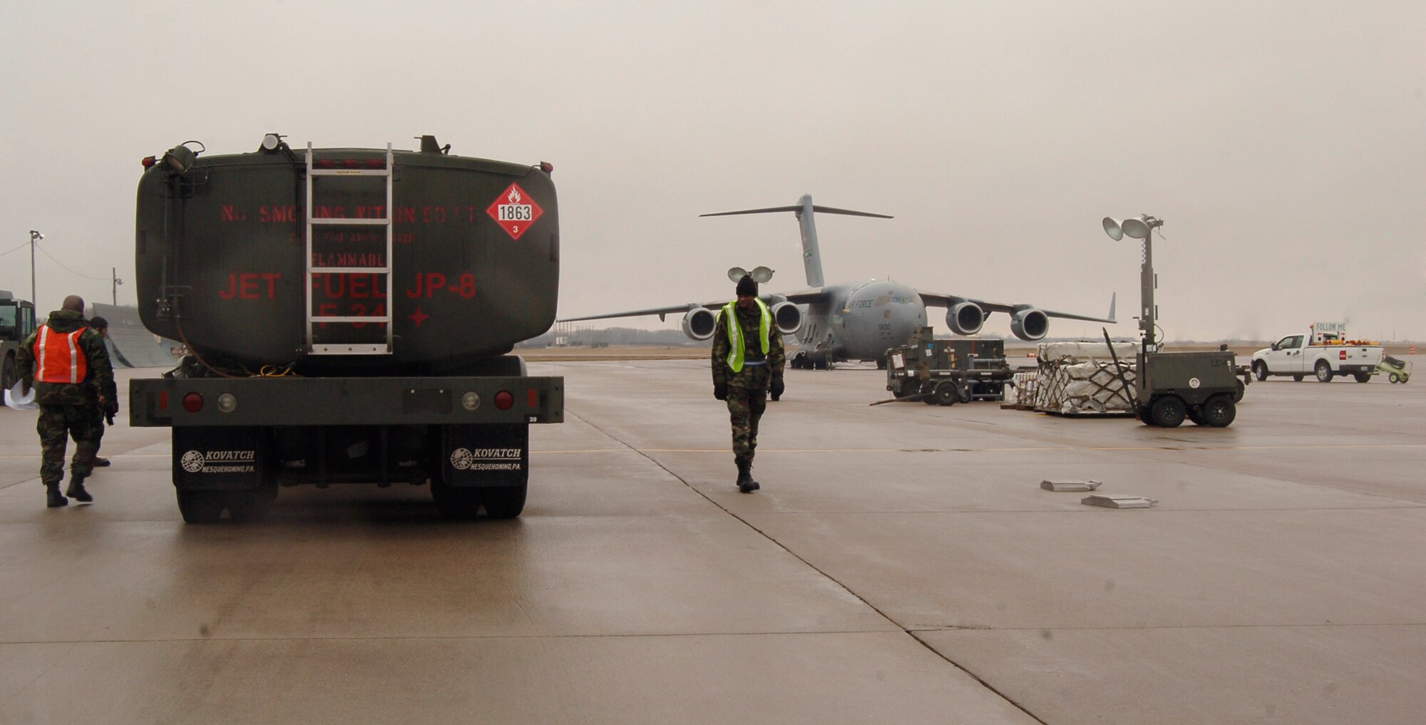MCCONNELL AIR FORCE BASE, Kan. -- Members of the 22nd Logistics Readiness Squadron weigh a Jet Fuel JP-8, F-34 tank trunk in the cargo deployment function area, Mar. 30. during an Operational Readiness Exercise, here. Airmen check all tanks and cargo are properly checked, weighed and safe for transportation before being loaded on the aircraft.  (Photo by Airman 1st Class Maria Ruiz)