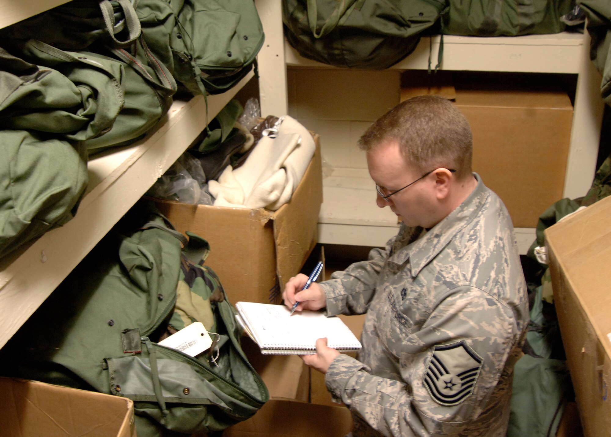 MCCONNELL AIR FORCE BASE, Kan. -- Master Sgt. Randy Johnson, 22nd Communications Squadron, double checks mobility bags assigned to the Comm. Squadron in the supply closet of Bldg 739, March 30, during an Operational Readiness Exercise, here. Every squadron assigned at McConnell must have a complete inventory of all mobility bags. (Photo by Senior Airman Anthony Mejia)