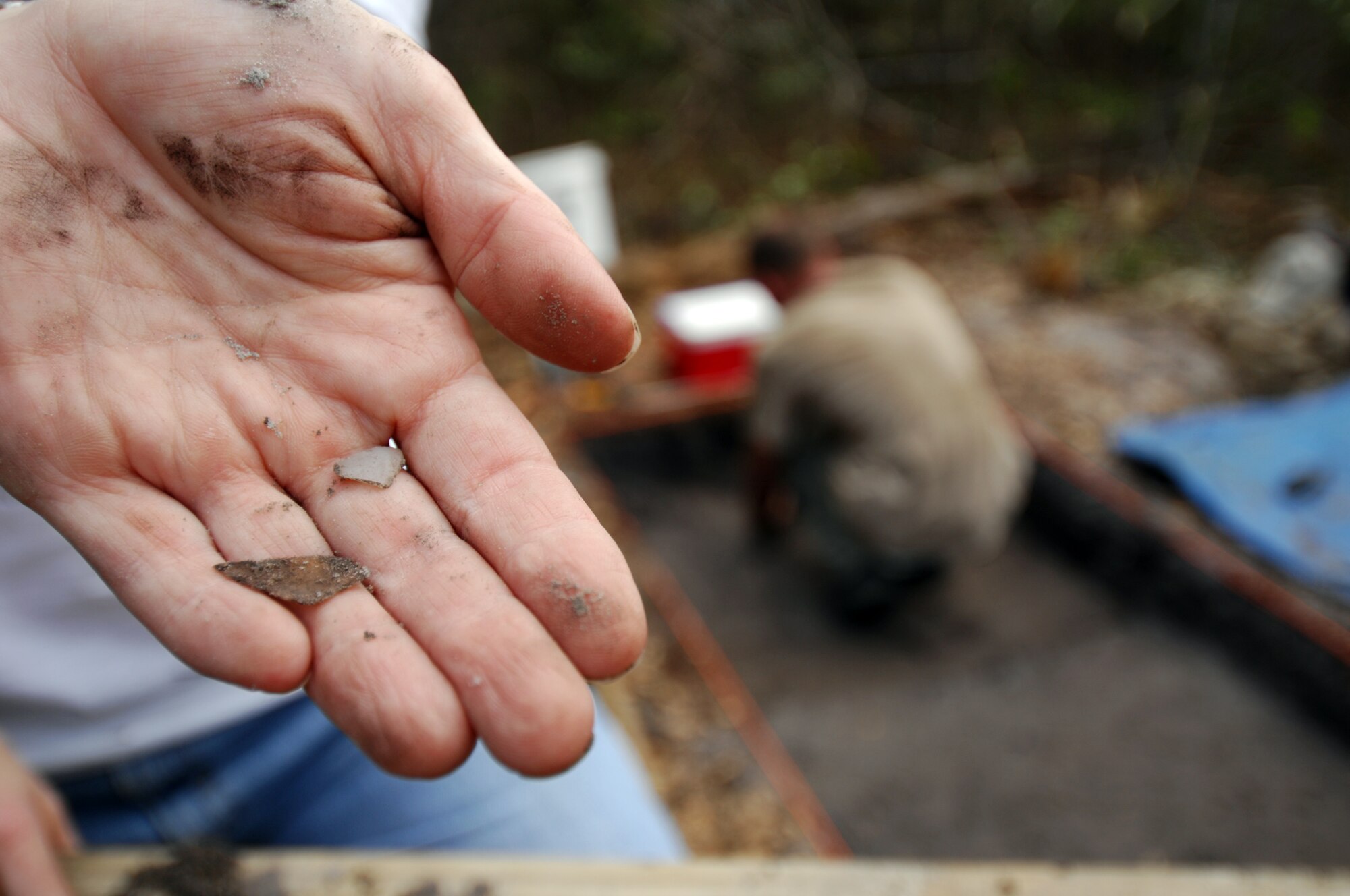 MOODY AIR FORCE BASE, Ga. -- Johnna Thackston, base archeologist and National Environmental Policy Act planner, holds artifacts found on Grand Bay range here, April 1. Johnna is working with archeologists contracted to determine whether or not the land here qualifies as being protected.  (U. S. Air Force Photo/Staff Sgt. Joshua T. Jasper)