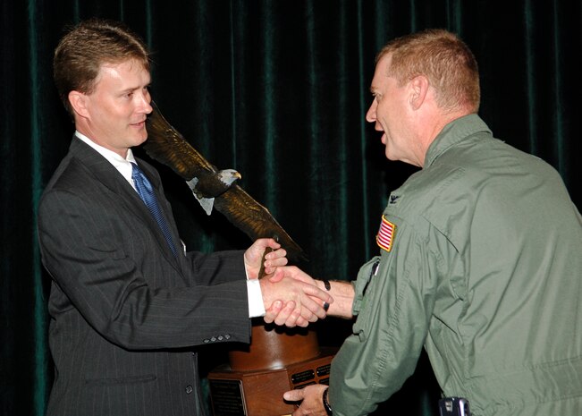 Gray Bridwell presents the Abilene Trophy for community support to Col. John ?Red? Millander during the annual Air Mobility Command Phoenix Rally held at MacDill AFB, Fla., March 27.  Mr. Bridwell is on the executive committee of the Military Relations Committee, Abilene Chamber of Commerce, Texas, and Colonel Millander is the 437th Airlift Wing commander. (U.S. Air Force photo/Senior Airman Nancy Hooks)