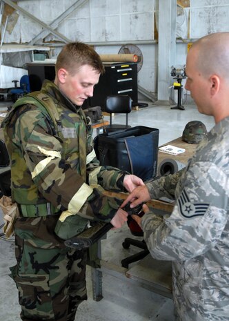 Staff Sgt. Ryan Jones briefs 1st Lt. Timothy Goodwillie on the proper clearing procedures for the M-16 assault rifle when returning it to the armory during ability to survive and operate training on base Wednesday.  Sergeant Jones is with the 437th Security Forces Squadron and Lieutenant Goodwillie is with the 15th Airlift Squadron. (U.S. Air Force photo/Airman 1st Class Timothy Taylor) 