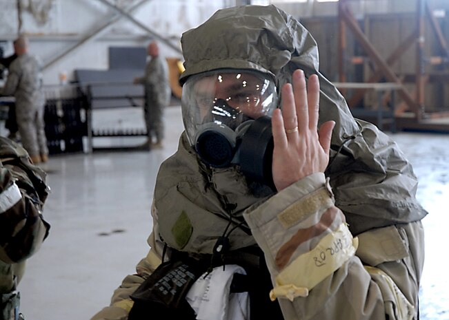 Master Sgt. James Monk checks his gas mask to ensure a tight seal is made between his face and the mask during ability to survive and operate training on base Wednesday. Sergeant Monk is with the 1st Combat Camera Squadron. (U.S. Air Force photo/Airman 1st Class Timothy Taylor)