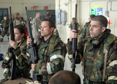 Airmen from various sections gather around a training table with their M16s in hand and pay attention to the 437th Security Forces Squadron training instructors on proper firing, clearing and cleaning of the M16 Assault Rifle during ability to survive and operate training on base Wednesday.  (U.S. Air Force photo/Airman 1st Class Timothy Taylor)