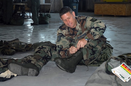 Tech. Sgt. Shawn McKeen dons mission-oriented protective posture gear on base Wednesday during ability to survive and operate training in preparation for the operational readiness inspection coming in August. The ORI will evaluate both the 437th and 315th Airlift Wings? ability to provide combat capability to air component command. Sergeant McKeen is a member of the 437th Services Squadron. (U.S. Air Force photo/Airman 1st Class Melissa White)