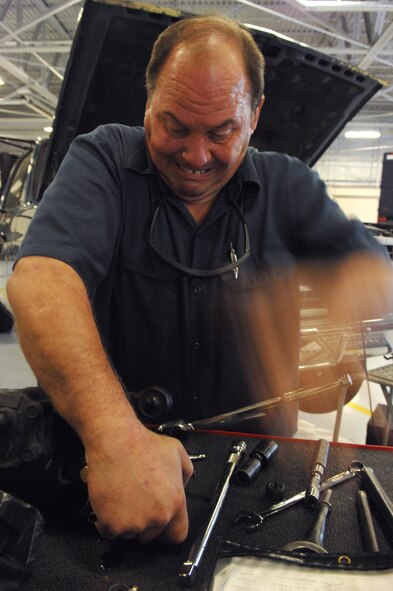 MOODY AIR FORCE BASE, Ga. – John Butler, 23rd Logistics Readiness Squadron heavy mobile mechanic, bangs his hand against a wrench to remove a power steering gear here April 2.  The gear had to be replaced in order to put the truck he was repairing back into service. (U.S. Air Force photo by Senior Airman Angelita Lawrence)