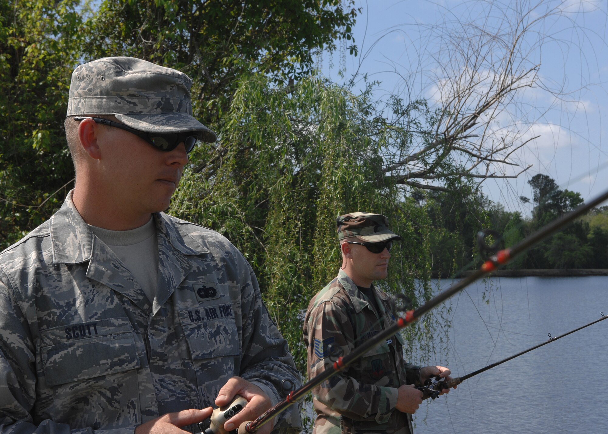 MOODY AIR FORCE BASE, Ga. -- Tech. Sgt. Michael Scott, 23rd Mission Support Group help desk NCO-in-charge, and Tech. Sgt. Chris McMahon, 23rd Communications Squadron, fish at Mission Lake during their lunch hour here April 2. Sergeant Scott and Sergeant McMahon fish at Mission Lake regularly. (U.S. Air Force photo by Airman 1st Class Brittany Barker)