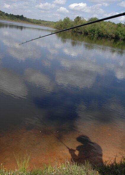 MOODY AIR FORCE BASE, Ga. -- Tech. Sgt. Michael Scott, 23rd Mission Support Group help desk NCO-in-charge, fishes at Moody's Mission Lake during his lunch hour here April 2. Sergeant Scott enjoys fishing and golfing at the base facilities in his free time. (U.S. Air Force photo by Airman 1st Class Brittany Barker)