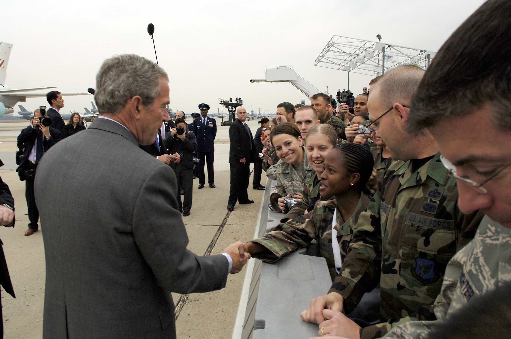 President of the United States George Bush shakes hands with Senior Airman Tamika Edwards, 305th Mission Support Group, during his visit to McGuire March 28. The president stopped at McGuire before departing to Freehold, N.J., on Marine One. (U.S. Air Force photo/Kenn Mann)