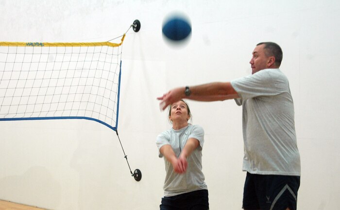 Erin Zweigart covers for Steven Dubriske as he hits during a game of wallyball for Wingman Day at the Fitness and Sports Center Monday. Zweigart and Dubriske are both with the 437th Airlift Wing Legal Office. (U.S. Air Force photo/Senior Airman Sam Hymas)