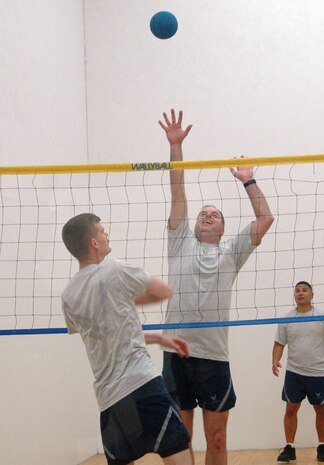 Michael Kyser prepares to hit the ball over Robert Sizelove during a game of wallyball for Wingman Day at the Fitness and Sports Center Monday. Kyser is with the 437th Airlift Wing Safety Office and Sizelove is with the 437 AW Public Affairs Office. (U.S. Air Force photo/Senior Airman Sam Hymas)