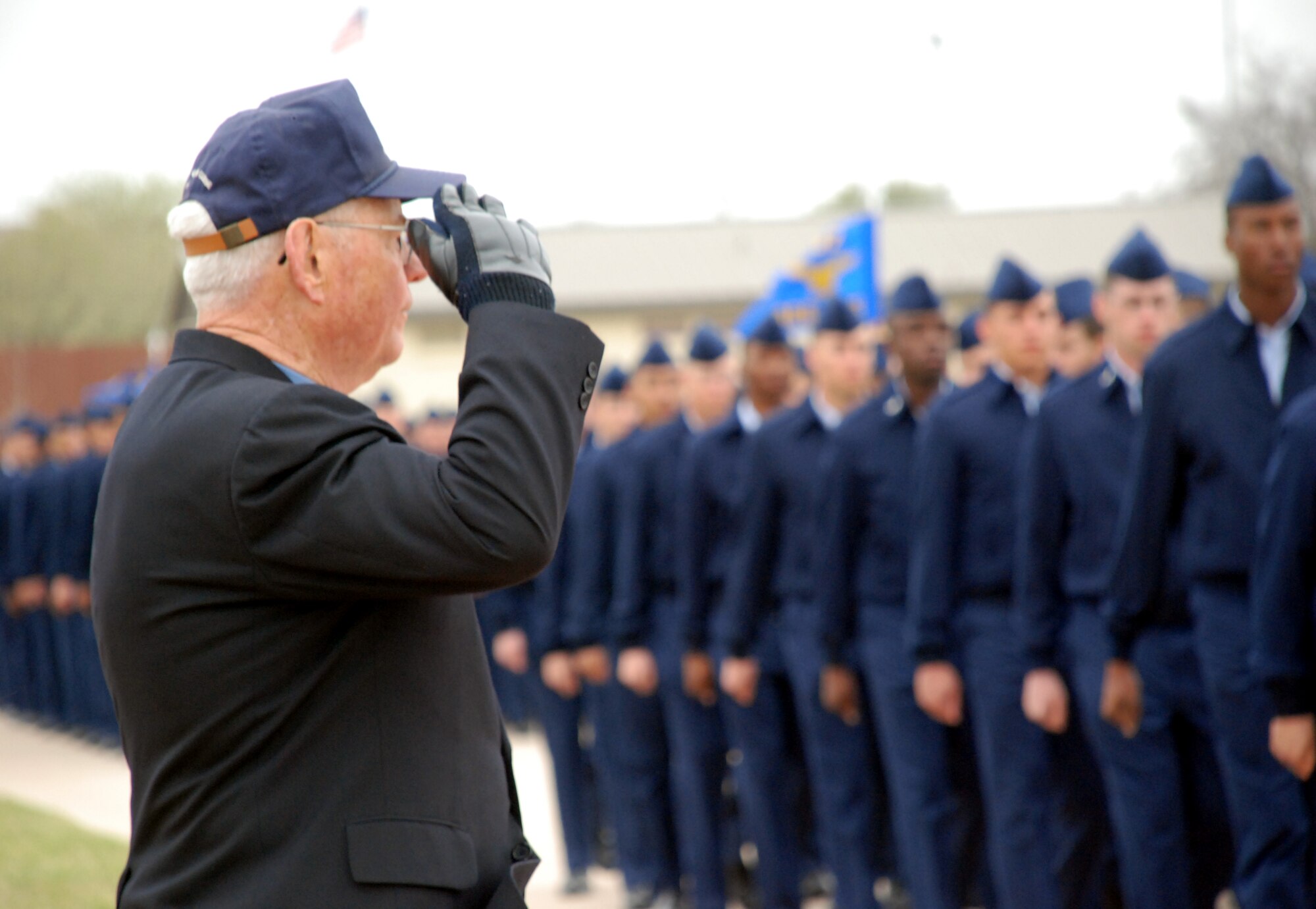 Chief Master Sgt. of the Air Force (ret.) Robert Gaylor, salutes passing Airmen during a parade March 28 while visiting Sheppard Air Force Base. Chief Gaylor visited Sheppard and spoke to about 2,000 Airmen, offering career advice and answering questions. (U.S. Air Force photo/Airman 1st Class Jacob Corbin).