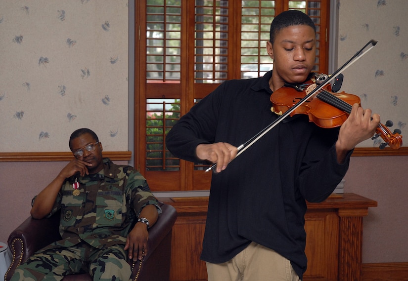 Daniel Davis plays the violin during his father's retirement ceremony March 18 at the chapel annex on base. Mr. Davis has been playing the violin since he was 12 years old and is the 19-year-old son of Chief Master Sgt. Reginald Davis who retired from the 437th Medical Group. (U.S. Air Force photo/Airman 1st Class Melissa White)
