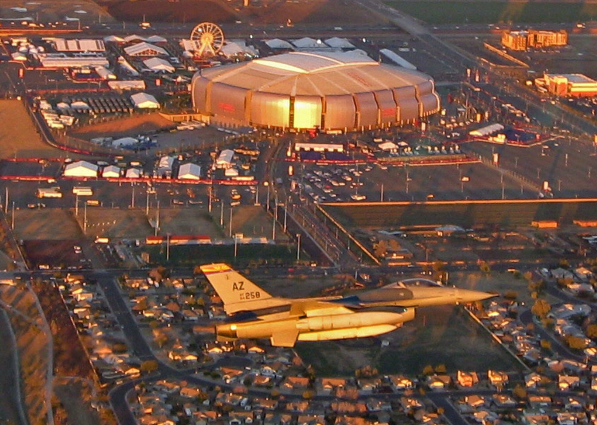 GLENDALE, Ariz. - Capt. Patrick McClelland, a pilot assigned to the Arizona Air National Guard’s 162nd Fighter Wing based in Tucson, flies an F-16 Fighting Falcon over University of Phoenix Stadium before Super Bowl weekend kicks off. The purpose of the pre-game flight was to raise public awareness that U.S. air defenses would be at work Feb. 3 enforcing the FAA’s temporary flight restriction over the National Football League’s championship game while ensuring the safety of the crowd. (Photo by Lt. Col. Moon Milham)