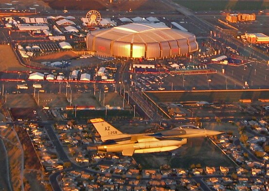GLENDALE, Ariz. - Capt. Patrick McClelland, a pilot assigned to the Arizona Air National Guard’s 162nd Fighter Wing based in Tucson, flies an F-16 Fighting Falcon over University of Phoenix Stadium before Super Bowl weekend kicks off. The purpose of the pre-game flight was to raise public awareness that U.S. air defenses would be at work Feb. 3 enforcing the FAA’s temporary flight restriction over the National Football League’s championship game while ensuring the safety of the crowd. (Photo by Lt. Col. Moon Milham)