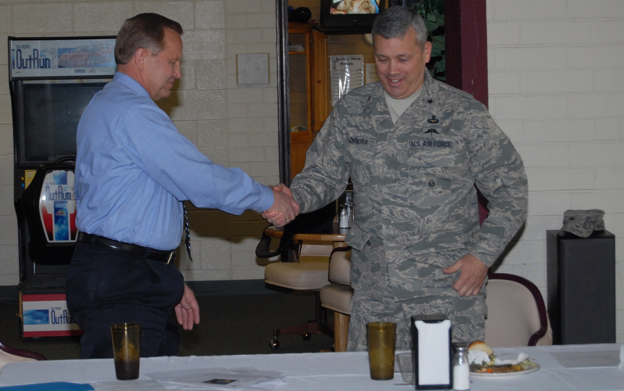 Brig. Gen. Michael Longoria, 93rd Air Ground Operations Wing Commander, shakes hands with (Ret.) Brig. Gen. Paul Dordal, former 23rd Wing Commander and President of the Harley Pope Chapter of the Air Force Association at Pope Air Force Base, N.C. March 27. General Longoria spoke to the AFA about the 93rd AGOW in relation to its Pope unit, the 18th Air Support Operations Group, and about general ground-combat missions for the Air Force. (U.S. Air Force Photo by 2nd Lt. Chris Hoyler)