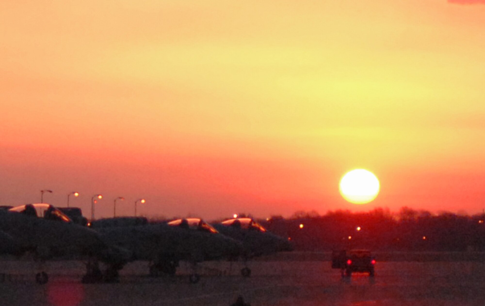 WHITEMAN AIR FORCE BASE, Mo. - The sun rises over A-10s parked on the flightline here March 26. The A-10s are assigned to the 442nd Fighter Wing. (U.S. Air Force photo/Staff Sgt. Jason Barebo)