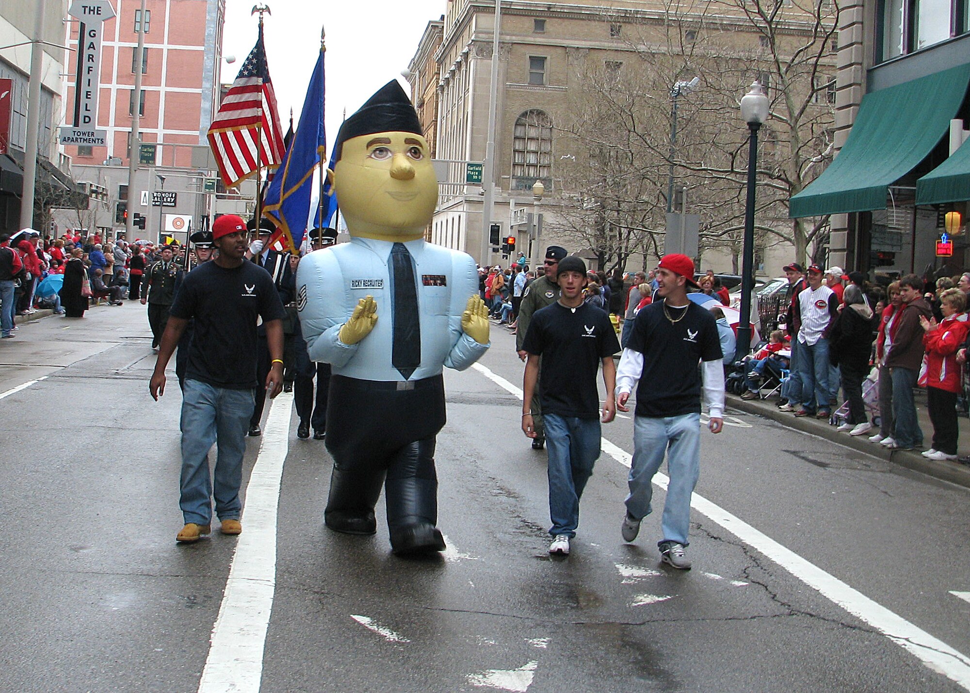 338th Recruiting Squadron Delayed Entry Program members march with Ricky the Recruiter and the Honor Guard in the 89th annual Findlay Market Cincinnati Reds Opening Day Parade March 31. The parade followed a 15-block route through downtown Cincinnati drawing more then 20,000 spectators. (Staff Sgt. Chad Tanner)
