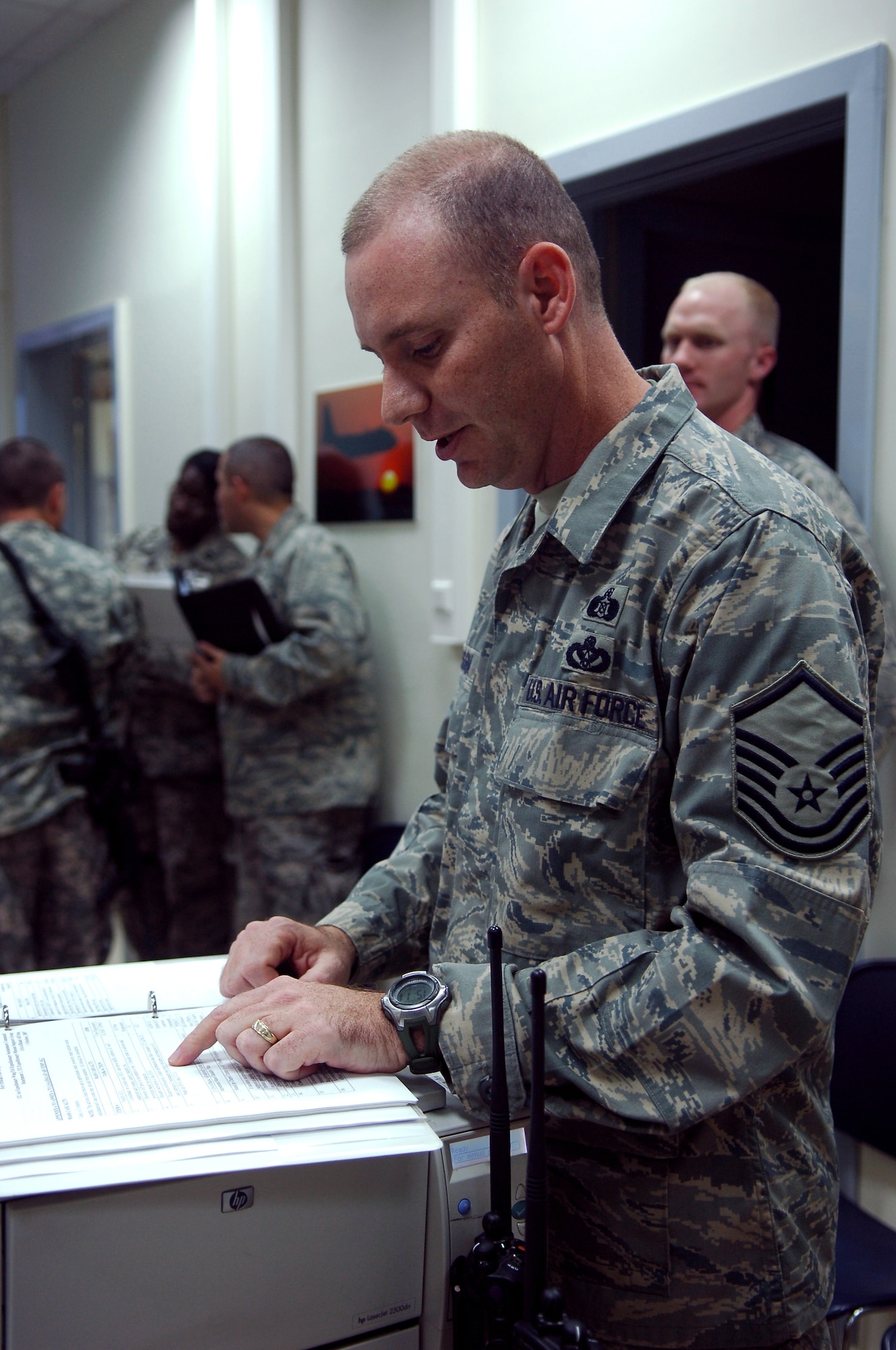 BALAD AIR BASE, Iraq -- Master Sgt. Michael Messina, 332nd Expeditionary Civil Engineer Squadron emergency management, guides members of the Joint Emergency Operations Center through a checklist during a battle drill here, March 31. Air Force and Army personnel worked together to respond to simulated base emergencies. Sergeant Messina is deployed from Tyndall Air Force Base, Fla. (U.S. Air Force photo /Staff Sgt. Mareshah Haynes)