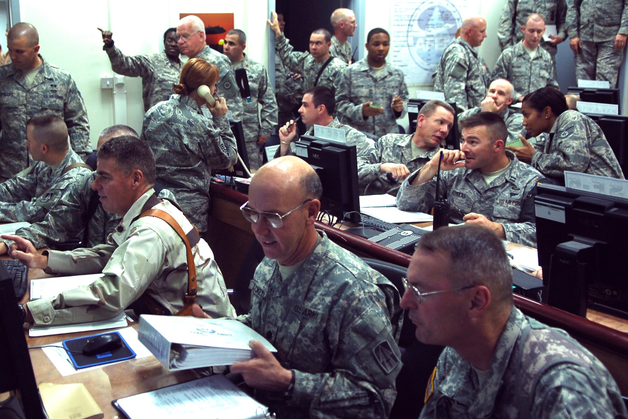 BALAD AIR BASE, Iraq -- Air Force and Army personnel teamed up to form the Joint Emergency Operations Center during a battle drill here, March 31. The drill was the first time the capabilities of the JEOC had been tested in Iraq. Several scenarios were acted out during the drill, including a simulated suicide bomber attack and a simulated unexploded rocket lodged in a fuel truck. (U.S. Air Force photo /Staff Sgt. Mareshah Haynes)