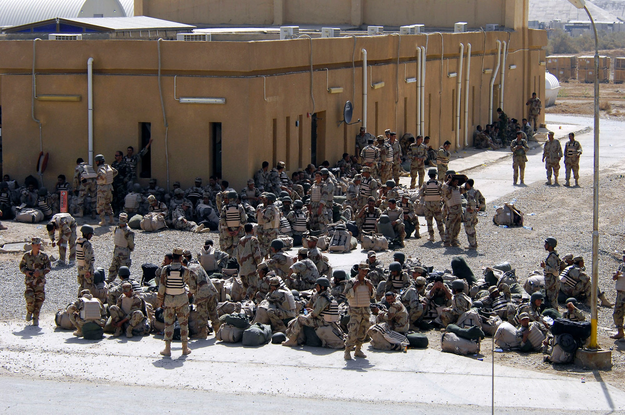 Members of the Iraqi army wait to board an Iraqi C-130 Hercules for a March 30 flight to Basra, Iraq, at New Al Muthana Air Base, Iraq. All processing, loading and transporting of the Iraqi troops is being conducted by the Iraqi air force. (U.S. Air Force photo/Tech. Sgt. Jeffrey Allen) 
