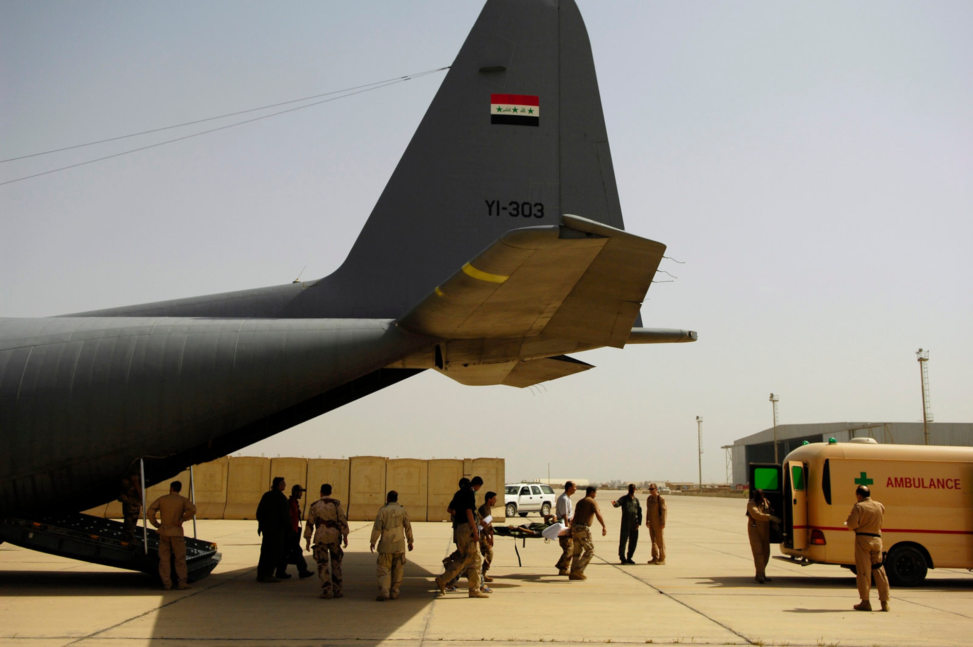 Members of the Iraqi air force unload a wounded Iraqi army soldier from an Iraqi air force C-130 Hercules after a March 30 flight from Basra, Iraq, to New Al Muthana Air Base, Iraq. All processing, loading and transporting of the Iraqi troops is being conducted by the Iraqi air force. (U.S. Air Force photo/Tech. Sgt. Jeffrey Allen) 
