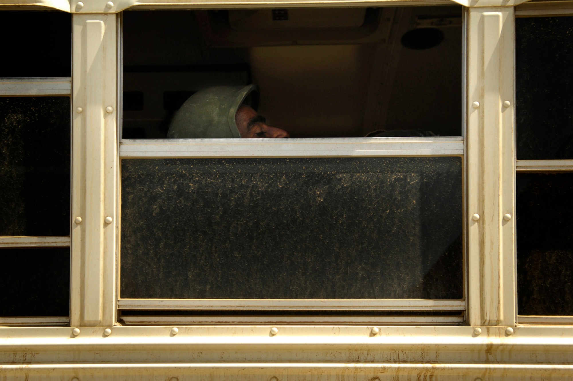 A member of the Iraqi army sits on a bus that will take him to an Iraqi air force C-130 Hercules before a March 30 flight to Basra, Iraq, at New Al Muthana Air Base, Iraq. All processing, loading and transporting of the Iraqi troops is being conducted by the Iraqi air force. (U.S. Air Force photo/Tech. Sgt. Jeffrey Allen)
