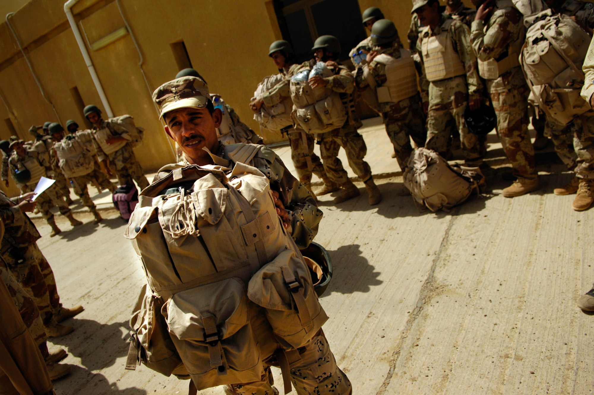 A member of the Iraqi army boards a bus that will take him to an Iraqi air force C-130 Hercules before a March 30 flight to Basra, Iraq, at New Al Muthana Air Base, Iraq. All processing, loading and transporting of the Iraqi troops is being conducted by the Iraqi air force. (U.S. Air Force photo/Tech. Sgt. Jeffrey Allen) 